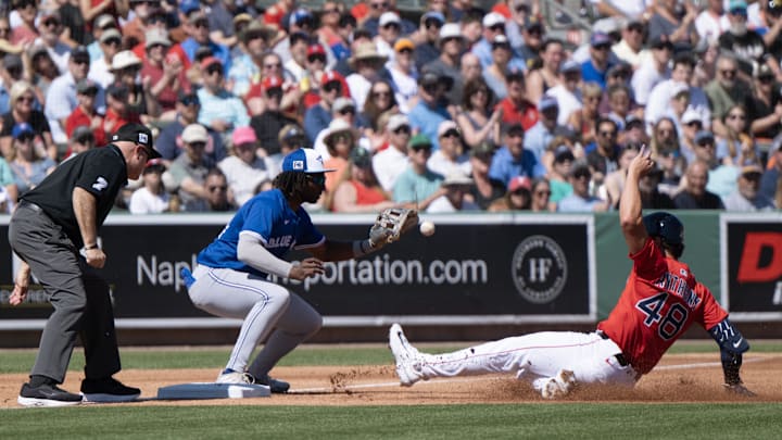 Toronto Blue Jays third baseman Charles McAdoo (84) just misses the tag on Boston’s Roman Anthony (48) during the first inning of their game at JetBlue Park at Fenway South in 2025.