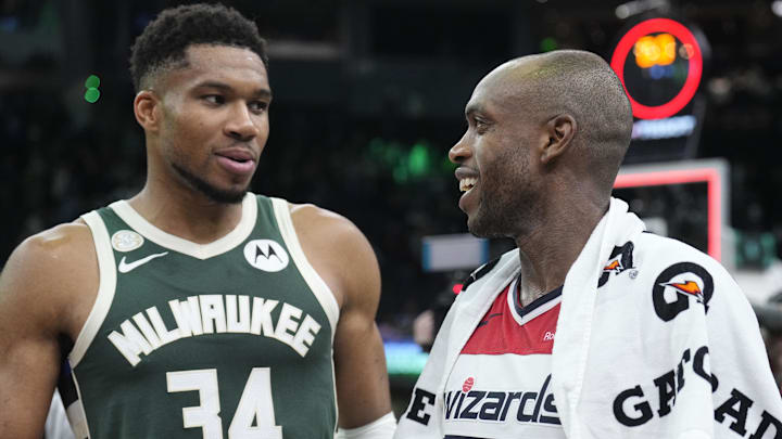 Oct 22, 2025; Milwaukee, Wisconsin, USA; Milwaukee Bucks forward Giannis Antetokounmpo (34) and Washington Wizards forward Khris Middleton (22) former teammates talk to each other after their game at Fiserv Forum. Mandatory Credit: Michael McLoone-Imagn Images