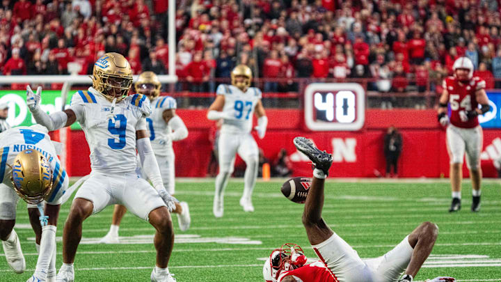 Nov 2, 2024; Lincoln, Nebraska, USA; Nebraska Cornhuskers wide receiver Jacory Barney Jr. (17) kicks the ball up as UCLA Bruins defensive back Kaylin Moore (9) moves to intercept during the fourth quarter at Memorial Stadium. Mandatory Credit: Dylan Widger-Imagn Images Nov 2, 2024; Lincoln, Nebraska, USA; Nebraska Cornhuskers wide receiver Jacory Barney Jr. (17) kicks the ball up as UCLA Bruins defensive back Kaylin Moore (9) moves to intercept during the fourth quarter at Memorial Stadium. Mandatory Credit: Dylan Widger-Imagn Images