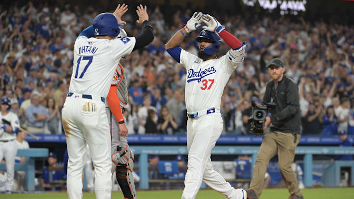 Aug 28, 2024; Los Angeles, California, USA;  Los Angeles Dodgers left fielder Teoscar Hernandez (37) crosses the plate after hitting a three-run home run scoring designated hitter Shohei Ohtani (17) and right fielder Mookie Betts (50) in the third inning against the Baltimore Orioles at Dodger Stadium.