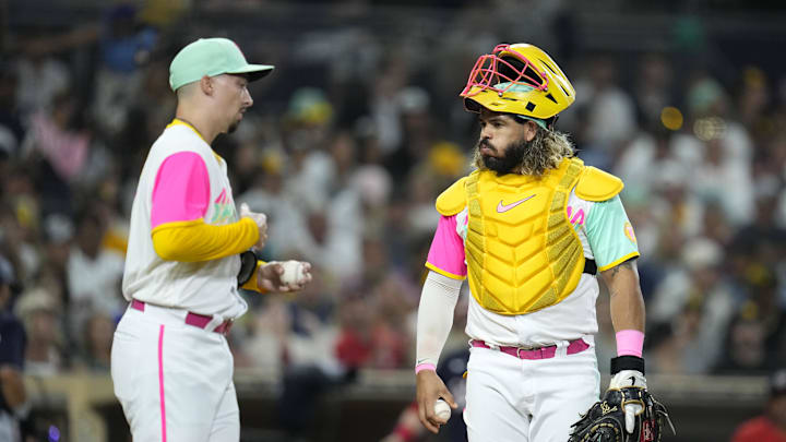 Aug 19, 2022; San Diego, California, USA;  San Diego Padres catcher Jorge Alfaro (38) and pitcher Blake Snell (left) react after Washington Nationals second baseman Cesar Hernandez (not pictured) scores during the fourth inning at Petco Park. Mandatory Credit: Ray Acevedo-Imagn Images