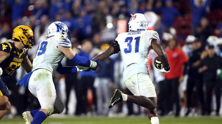 Dec 17, 2024; Frisco, TX, USA;  Memphis Tigers linebacker Elijah Herring (31) runs with the ball after making an interception at the end of the game against the West Virginia Mountaineers at Toyota Stadium. Mandatory Credit: Tim Heitman-Imagn Images