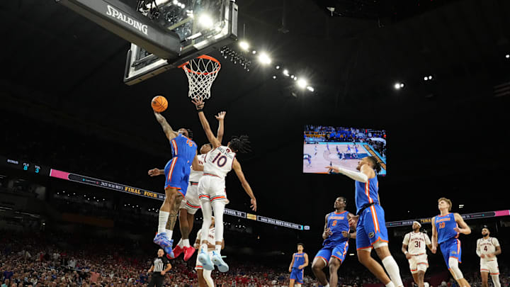 Apr 5, 2025; San Antonio, TX, USA; Florida Gators guard Alijah Martin (15) dunks the ball against Auburn Tigers guard Tahaad Pettiford (0) and guard Chad Baker-Mazara (10) during the second half in the semifinals of the men's Final Four of the 2025 NCAA Tournament at the Alamodome. Mandatory Credit: Bob Donnan-Imagn Images
