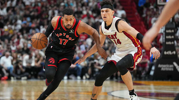 Apr 14, 2024; Miami, Florida, USA;  Toronto Raptors forward Garrett Temple (17) brings the ball up the court as Miami Heat guard Tyler Herro (14) follows on the play during the second half at Kaseya Center. Mandatory Credit: Jim Rassol-Imagn Images