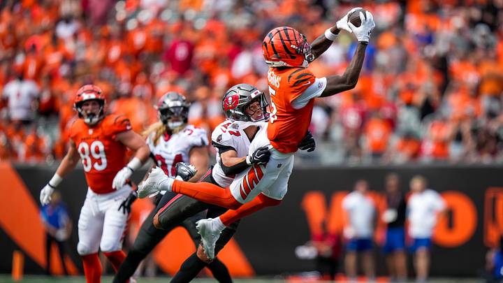 Cincinnati Bengals wide receiver Tee Higgins (5) makes a leaping catch over Tampa Bay Buccaneers cornerback Zyon McCollum (27) in the fourth quarter of the NFL Week 1 game between the Cincinnati Bengals and the Tampa Bay Buccaneers at Paycor Stadium in Cincinnati on Sunday, Sept. 13, 2026. Cincinnati Bengals wide receiver Tee Higgins (5) makes a leaping catch over Tampa Bay Buccaneers cornerback Zyon McCollum (27) in the fourth quarter of the NFL Week 1 game between the Cincinnati Bengals and the Tampa Bay Buccaneers at Paycor Stadium in Cincinnati on Sunday, Sept. 13, 2026.