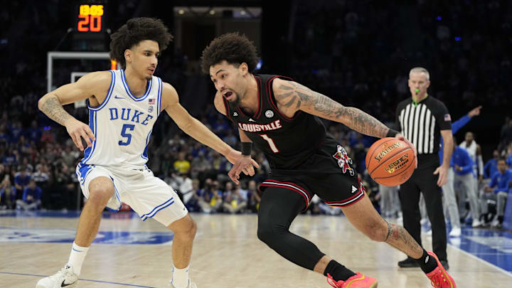 Mar 15, 2025; Charlotte, NC, USA; Louisville Cardinals guard J'Vonne Hadley (1) drives against Duke Blue Devils guard Tyrese Proctor (5) in the second half of the 2025 ACC Conference Championship game at Spectrum Center. Mandatory Credit: Bob Donnan-Imagn Images