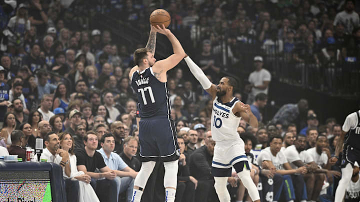 Dallas Mavericks guard Luka Doncic (77) shoots against Minnesota Timberwolves guard Mike Conley.