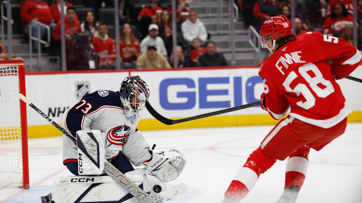 Apr 7, 2026; Detroit, Michigan, USA;  Columbus Blue Jackets goaltender Jet Greaves (73) makes a save on Detroit Red Wings center Emmitt Finnie (58) in the second period at Little Caesars Arena. Mandatory Credit: Rick Osentoski-Imagn Images