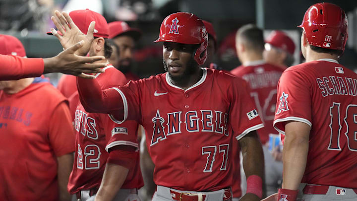 Apr 17, 2025; Arlington, Texas, USA; Los Angeles Angels shortstop Tim Anderson (77) celebrates with teammates in the dugout after scoring against the Texas Rangers during the fifth inning at Globe Life Field. Mandatory Credit: Jim Cowsert-Imagn Images