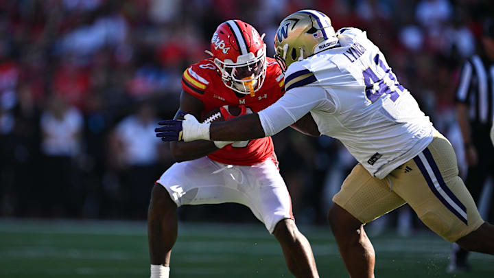 Maryland running back DeJuan Williams (0) is dropped for a loss by Washington edge rusher Deshawn Lynch (41).