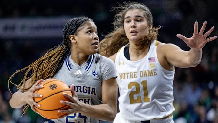 Feb 23, 2023; South Bend, Indiana, USA; Georgia Tech Yellow Jackets guard Kara Dunn (25) drives to the basket as Notre Dame Fighting Irish forward Maddy Westbeld (21) defends in the first half at the Purcell Pavilion. Mandatory Credit: Matt Cashore-Imagn Images