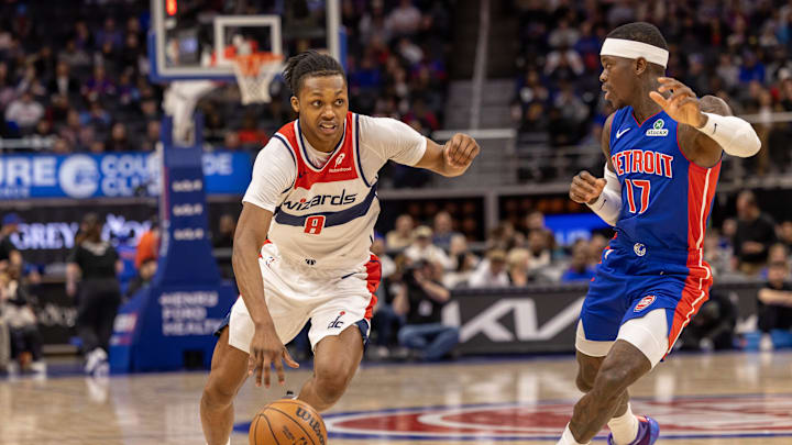 Mar 11, 2025; Detroit, Michigan, USA; Detroit Pistons guard Dennis Schroder (17) defends against Washington Wizards guard Bub Carrington (8) during the first half at Little Caesars Arena. Mandatory Credit: David Reginek-Imagn Images