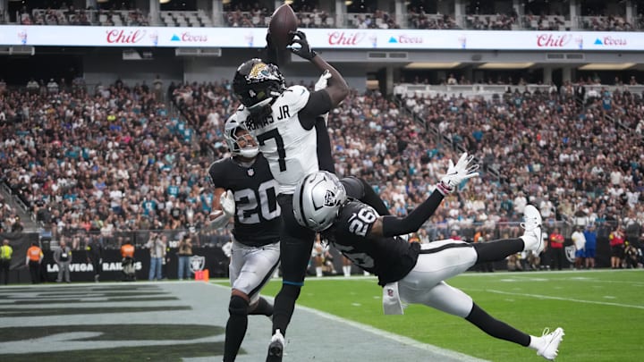 Nov 2, 2025; Paradise, Nevada, USA; Jacksonville Jaguars wide receiver Brian Thomas Jr. (7) attempts to catch the ball against Las Vegas Raiders safety Isaiah Pola-Mao (20) and cornerback Darien Porter (26) in the first half at Allegiant Stadium. Mandatory Credit: Kirby Lee-Imagn Images Nov 2, 2025; Paradise, Nevada, USA; Jacksonville Jaguars wide receiver Brian Thomas Jr. (7) attempts to catch the ball against Las Vegas Raiders safety Isaiah Pola-Mao (20) and cornerback Darien Porter (26) in the first half at Allegiant Stadium. Mandatory Credit: Kirby Lee-Imagn Images