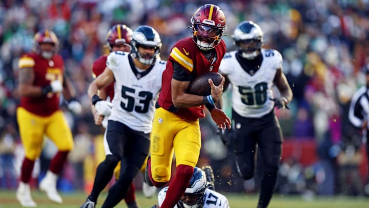 Dec 22, 2024; Landover, Maryland, USA; Washington Commanders quarterback Jayden Daniels (5) runs the ball against Philadelphia Eagles linebacker Nakobe Dean (17) during the third quarter at Northwest Stadium. Mandatory Credit: Peter Casey-Imagn Images Dec 22, 2024; Landover, Maryland, USA; Washington Commanders quarterback Jayden Daniels (5) runs the ball against Philadelphia Eagles linebacker Nakobe Dean (17) during the third quarter at Northwest Stadium. Mandatory Credit: Peter Casey-Imagn Images
