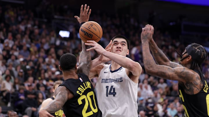 Utah Jazz forward John Collins (20) fouls Memphis Grizzlies center Zach Edey (14) on Wednesday.