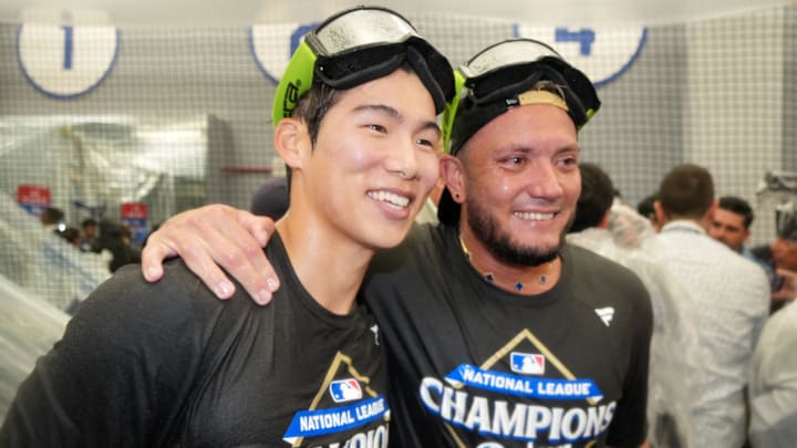 Oct 17, 2025; Los Angeles, California, USA; Los Angeles Dodgers second baseman Hyeseong Kim (6) celebrates with second baseman Miguel Rojas (72) in the dugout after defeating the Milwaukee Brewers in game four of the NLCS round for the 2025 MLB playoffs at Dodger Stadium. Mandatory Credit: Kirby Lee-Imagn Images