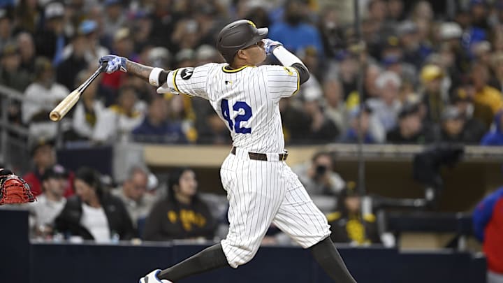 Apr 15, 2025; San Diego, California, USA; San Diego Padres third baseman Manny Machado (13) hits a solo home run during the fifth inning against the Chicago Cubs at Petco Park. Mandatory Credit: Denis Poroy-Imagn Images