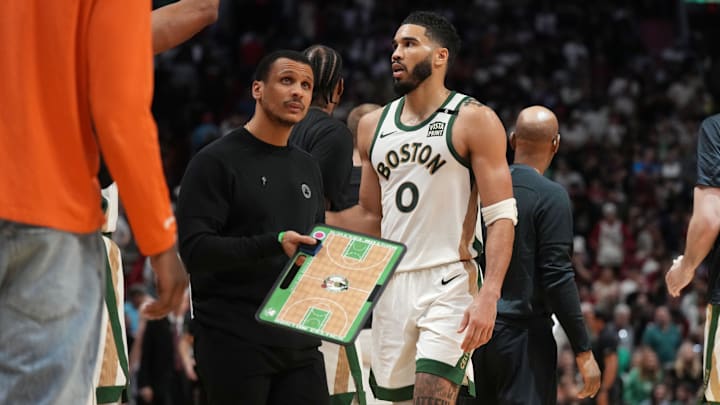 Feb 11, 2024; Miami, Florida, USA;  Boston Celtics head coach Joe Mazzulla and forward Jayson Tatum (0) during a timeout the second half at Kaseya Center against the Miami Heat. Mandatory Credit: Jim Rassol-Imagn Images