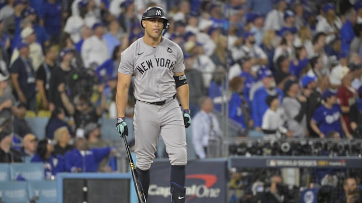 Oct 25, 2024; Los Angeles, California, USA; New York Yankees designated hitter Giancarlo Stanton (27) hits two-run home run in the sixth inning against the Los Angeles Dodgers during game one of the 2024 MLB World Series at Dodger Stadium. Mandatory Credit:  Jayne Kamin-Oncea-Imagn Images