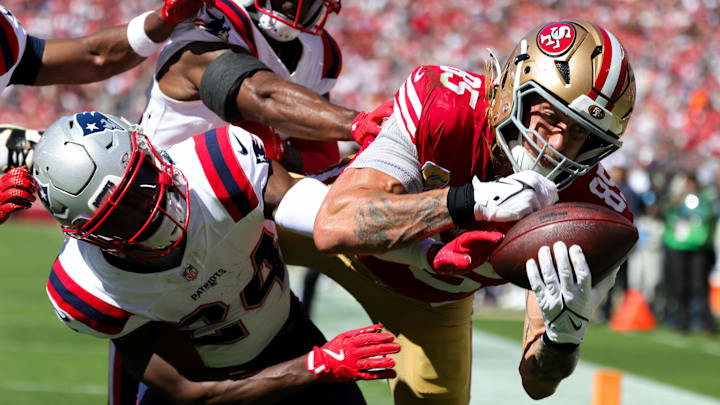 Sep 29, 2024; Santa Clara, California, USA; San Francisco 49ers tight end George Kittle (85) catches a touchdown against New England Patriots safety Dell Pettus (24) during the second quarter at Levi's Stadium. Mandatory Credit: Sergio Estrada-Imagn Images