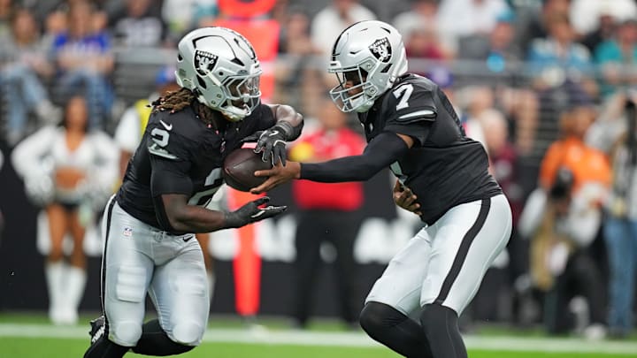 Nov 2, 2025; Paradise, Nevada, USA; Las Vegas Raiders quarterback Geno Smith (7) hands off the ball to Las Vegas Raiders running back Ashton Jeanty (2) during the first quarter against the Jacksonville Jaguars at Allegiant Stadium. Mandatory Credit: Kirby Lee-Imagn Images