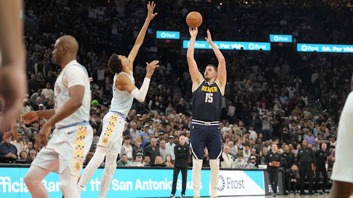 Denver Nuggets center Nikola Jokic (15) shoots the ball over San Antonio Spurs center Victor Wembanyama (1) during the second half at Frost Bank Center. Mandatory Credit: Scott Wachter-Imagn Images