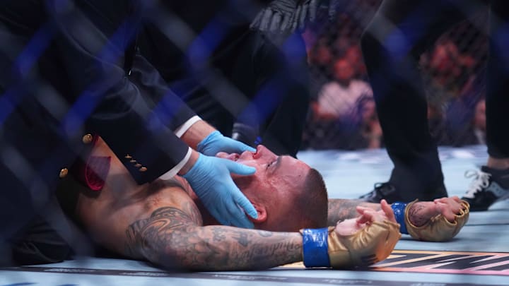 Jun 1, 2024; Newark, New Jersey, USA; Dustin Poirier (blue gloves) is examined by medical staff after the fight against Islam Makhachev (red gloves) during UFC 302 at Prudential Center. Mandatory Credit: Joe Camporeale-Imagn Images Jun 1, 2024; Newark, New Jersey, USA; Dustin Poirier (blue gloves) is examined by medical staff after the fight against Islam Makhachev (red gloves) during UFC 302 at Prudential Center. Mandatory Credit: Joe Camporeale-Imagn Images