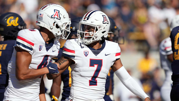 Sep 24, 2022; Berkeley, California, USA; Arizona Wildcats wide receiver Tetairoa McMillan (4) celebrates with quarterback Jayden de Laura (7) after catching a touchdown pass against the California Golden Bears during the second quarter at FTX Field at California Memorial Stadium. Mandatory Credit: Darren Yamashita-USA TODAY Sports