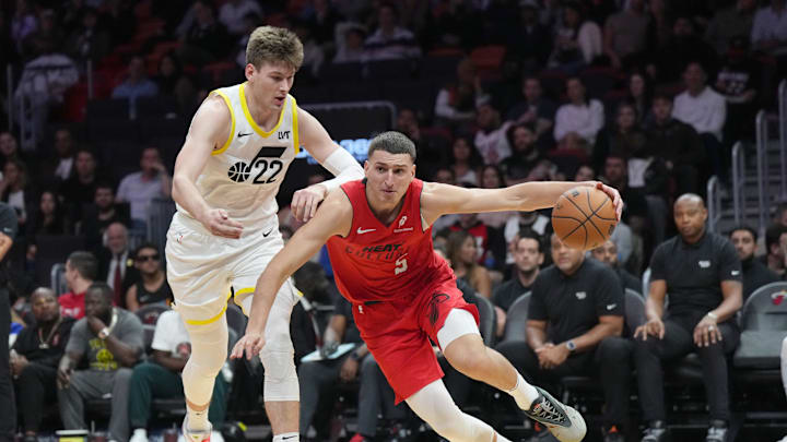 Jan 4, 2025; Miami, Florida, USA;  Miami Heat forward Nikola Jovic (5) drives past Utah Jazz forward Kyle Filipowski (22) during the second half at Kaseya Center. Mandatory Credit: Jim Rassol-Imagn Images