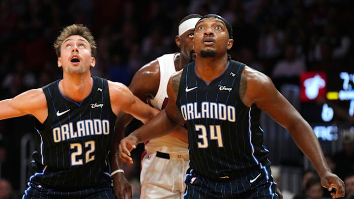 Oct 23, 2024; Miami, Florida, USA;  Orlando Magic forward Franz Wagner (22) and center Wendell Carter Jr. (34) battle for rebound position with Miami Heat center Bam Adebayo (13) during the first half at Kaseya Center. Mandatory Credit: Jim Rassol-Imagn Images