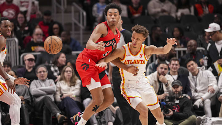 Jan 25, 2025; Atlanta, Georgia, USA; Atlanta Hawks guard Dyson Daniels (5) knocks the ball away from Toronto Raptors forward Scottie Barnes (4) during the first half at State Farm Arena. Mandatory Credit: Dale Zanine-Imagn Images