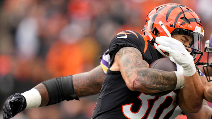 Cincinnati Bengals running back Chase Brown (30) protects the ball on a carry in the second quarter