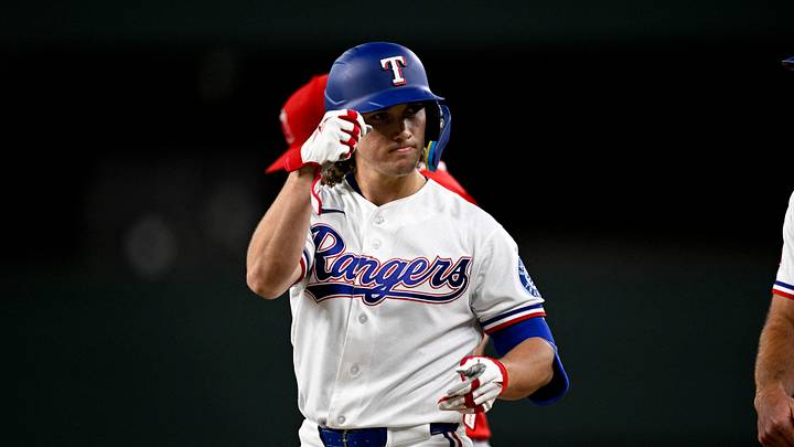 Jul 9, 2026; Arlington, Texas, USA; Texas Rangers center fielder Cam Cauley (27) celebrates after he hits a single against the Los Angeles Angels during the second inning at Globe Life Field. Mandatory Credit: Jerome Miron-Imagn Images