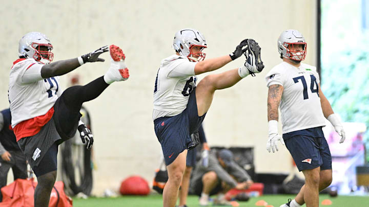 Jun 10, 2025; Foxborough, MA, USA; New England Patriots offensive tackle Mike Onwenu (71), guard Cole Strange (69) and offensive lineman Jack Conley (74) stretch during minicamp held in the WIN Field House at Gillette Stadium. Mandatory Credit: Eric Canha-Imagn Images