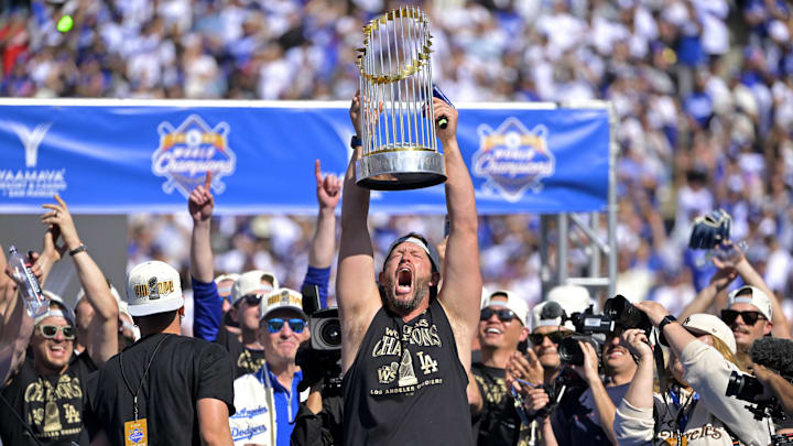 Nov 1, 2024; Los Angeles, CA, USA;  Los Angeles Dodgers starting pitcher Clayton Kershaw (22) lifts the World Series Championship Trophy during the team celebration at Dodger Stadium. Mandatory Credit: Jayne Kamin-Oncea-Imagn Images