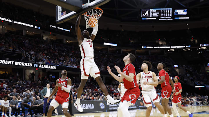 Mar 21, 2025; Cleveland, OH, USA;Alabama Crimson Tide center Clifford Omoruyi (11) dunks in the second half against the Robert Morris Colonials  during the NCAA Tournament First Round at Rocket Arena. Mandatory Credit: Rick Osentoski-Imagn Images
