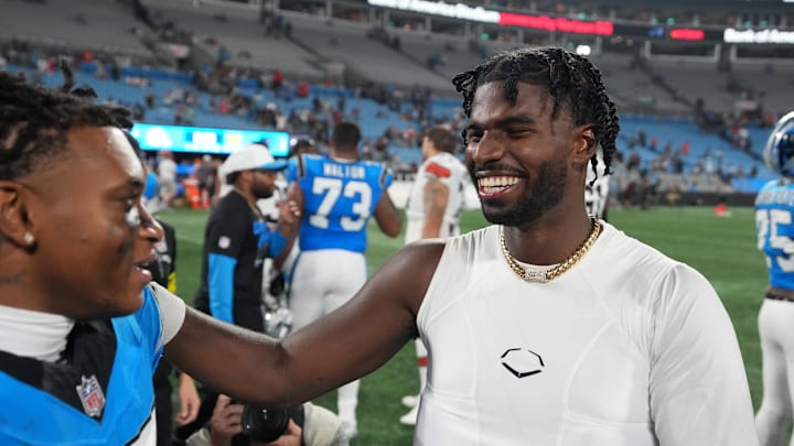 Aug 8, 2025; Charlotte, North Carolina, USA;  Cleveland Browns quarterback Shedeur Sanders (12) with Carolina Panthers wide receiver Jimmy Horn Jr. (15) after the game at Bank of America Stadium. 