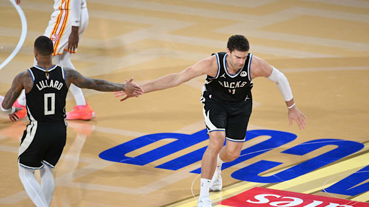 Dec 14, 2024; Las Vegas, Nevada, USA; Milwaukee Bucks center Brook Lopez (11) and guard Damian Lillard (0) react during the fourth quarter against the Atlanta Hawks in a semifinal of the 2024 Emirates NBA Cup at T-Mobile Arena. Mandatory Credit: Candice Ward-Imagn Images Dec 14, 2024; Las Vegas, Nevada, USA; Milwaukee Bucks center Brook Lopez (11) and guard Damian Lillard (0) react during the fourth quarter against the Atlanta Hawks in a semifinal of the 2024 Emirates NBA Cup at T-Mobile Arena. Mandatory Credit: Candice Ward-Imagn Images