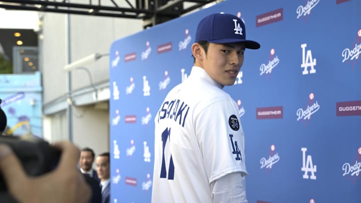 Jan 22, 2025; Los Angeles, CA, USA;  Los Angeles Dodgers pitcher Roki Sasaki (11) is photographed by media during an introductory press conference at Dodger Stadium. Mandatory Credit: Jayne Kamin-Oncea-Imagn Images  