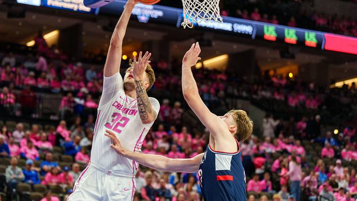 Jan 31, 2026; Omaha, Nebraska, USA; Creighton Bluejays forward Owen Freeman (32) shoots the ball against Connecticut Huskies guard Braylon Mullins (24) during the second half at CHI Health Center Omaha. Mandatory Credit: Dylan Widger-Imagn Images