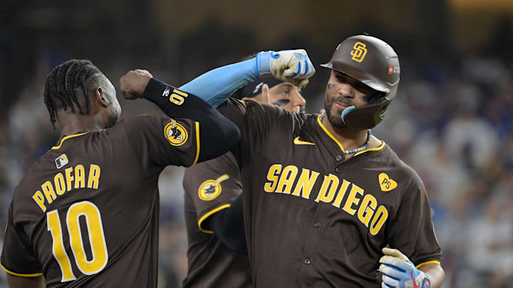 Oct 6, 2024; Los Angeles, California, USA; San Diego Padres second baseman Xander Bogaerts (2) celebrates with outfielder Jurickson Profar (10) after hitting a solo home run in the eighth inning against the Los Angeles Dodgers during game two of the NLDS for the 2024 MLB Playoffs at Dodger Stadium. Mandatory Credit: Jayne Kamin-Oncea-Imagn Images