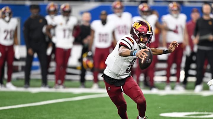 Jan 18, 2025; Detroit, Michigan, USA; Washington Commanders quarterback Jayden Daniels (5) scrambles out of the pocket during the fourth quarter against Detroit Lions in a 2025 NFC divisional round game at Ford Field. Mandatory Credit: Lon Horwedel-Imagn Images