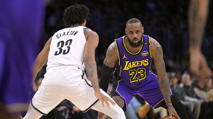 Jan 17, 2025; Los Angeles, California, USA;  Brooklyn Nets center Nic Claxton (33) guards Los Angeles Lakers forward LeBron James (23) at Crypto.com Arena. Mandatory Credit: Jayne Kamin-Oncea-Imagn Images