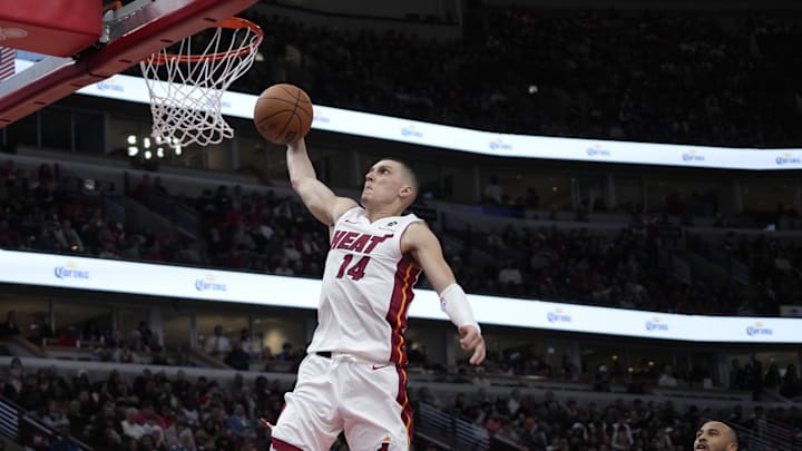 Apr 16, 2025; Chicago, Illinois, USA; Miami Heat guard Tyler Herro (14) goes up for a dunk on Chicago Bulls forward Talen Horton-Tucker (22) during the second half at United Center. Mandatory Credit: David Banks-Imagn Images