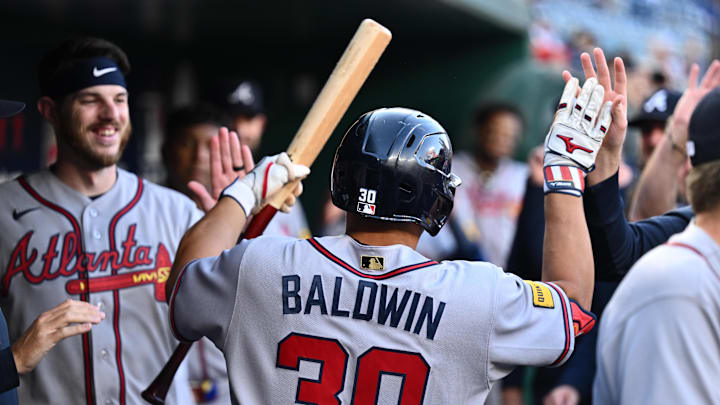 Apr 22, 2026; Washington, District of Columbia, USA;  Atlanta Braves catcher Drake Baldwin (30) celebrates in the dugout after hitting a home run in the first inning against the Washington Nationals at Nationals Park. Mandatory Credit: Jamie Sabau-Imagn Images