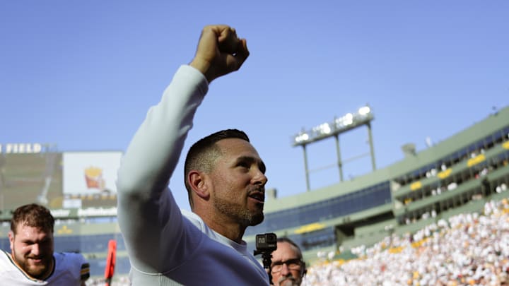 Oct 20, 2024; Green Bay, Wisconsin, USA;  Green Bay Packers head coach Matt LaFleur celebrates while walking off the field following the game against the Houston Texans at Lambeau Field. Mandatory Credit: Jeff Hanisch-Imagn Images