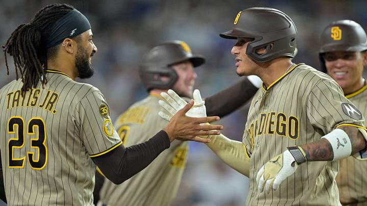 Sep 23, 2026; Los Angeles, California, USA; San Diego Padres right fielder Fernando Tatis Jr. (23) congratulates third baseman Manny Machado (13) after hitting a two-run home run during the fourth inning against the Los Angeles Dodgers at Dodger Stadium. Mandatory Credit: Jayne Kamin-Oncea-Imagn Images