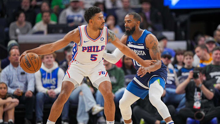 Mar 4, 2025; Minneapolis, Minnesota, USA; Philadelphia 76ers guard Quentin Grimes (5) dribbles against the Minnesota Timberwolves guard Mike Conley (10) in the first quarter at Target Center. Mandatory Credit: Brad Rempel-Imagn Images