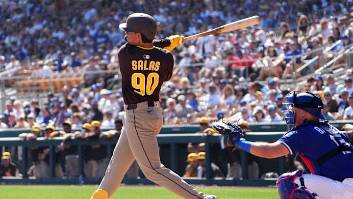 Feb 23, 2025; Phoenix, Arizona, USA; San Diego Padres catcher Ethan Salas (90) hits a double against the Los Angeles Dodgers during the second inning at Camelback Ranch-Glendale. Mandatory Credit: Joe Camporeale-Imagn Images