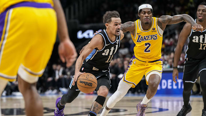 Jan 30, 2024; Atlanta, Georgia, USA; Atlanta Hawks guard Trae Young (11) dribbles past  Los Angeles Lakers forward Jarred Vanderbilt (2) during the second half at State Farm Arena. Mandatory Credit: Dale Zanine-USA TODAY Sports